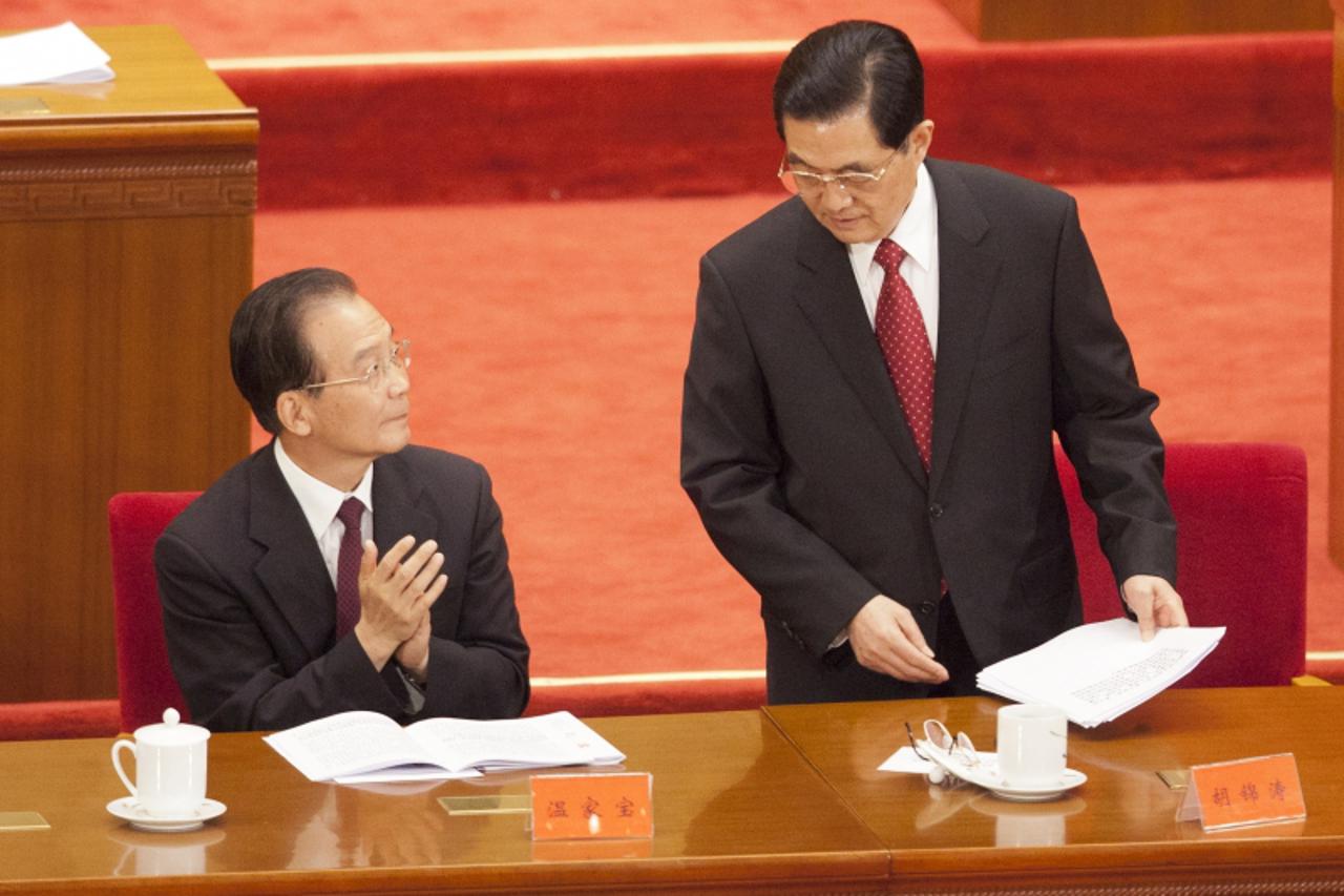 \'epa02804072 Hu Jintao, president of China and general secretary of the Chinese Communist Party (R) speaks with Premier Wen Jiabao after delivering a speech at a special event marking the 90th annive