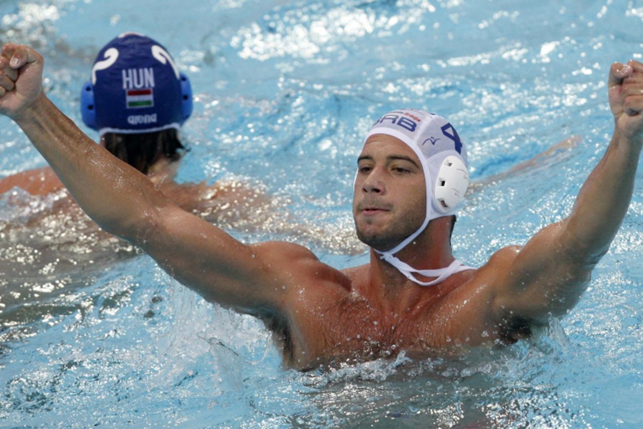 'Vanja Udovicic of Serbia reacts after scoring against Hungary at the European Water Polo Championships bronze medal match in Zagreb September 11, 2010. REUTERS/Nikola Solic (CROATIA - Tags: SPORT WAT