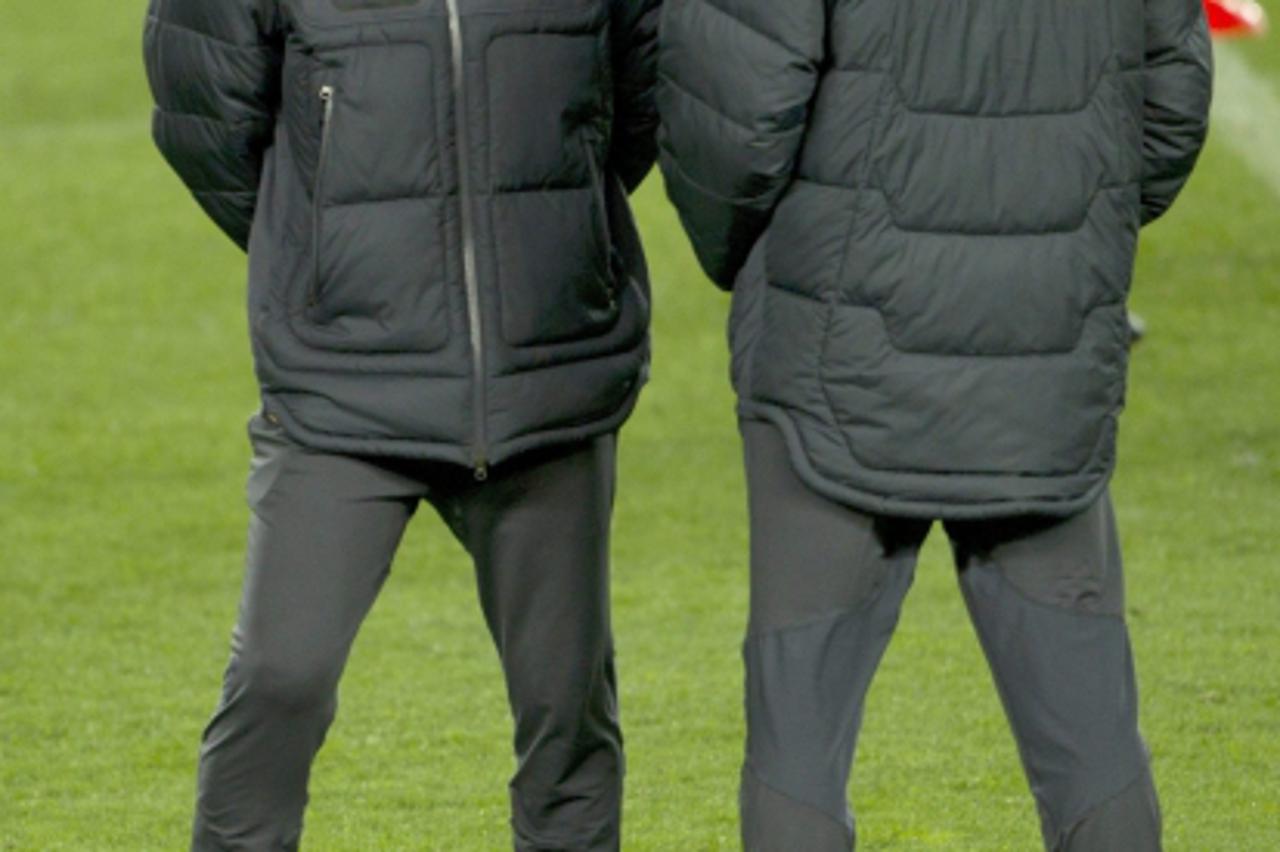 'FC Barcelona's Spanish coach Pep Guardiola (L) and his assistant Tito Vilanova, during a training session held at Camp Nou stadium in Barcelona, northeastern Spain, 06 March 2012, on the eve of the 