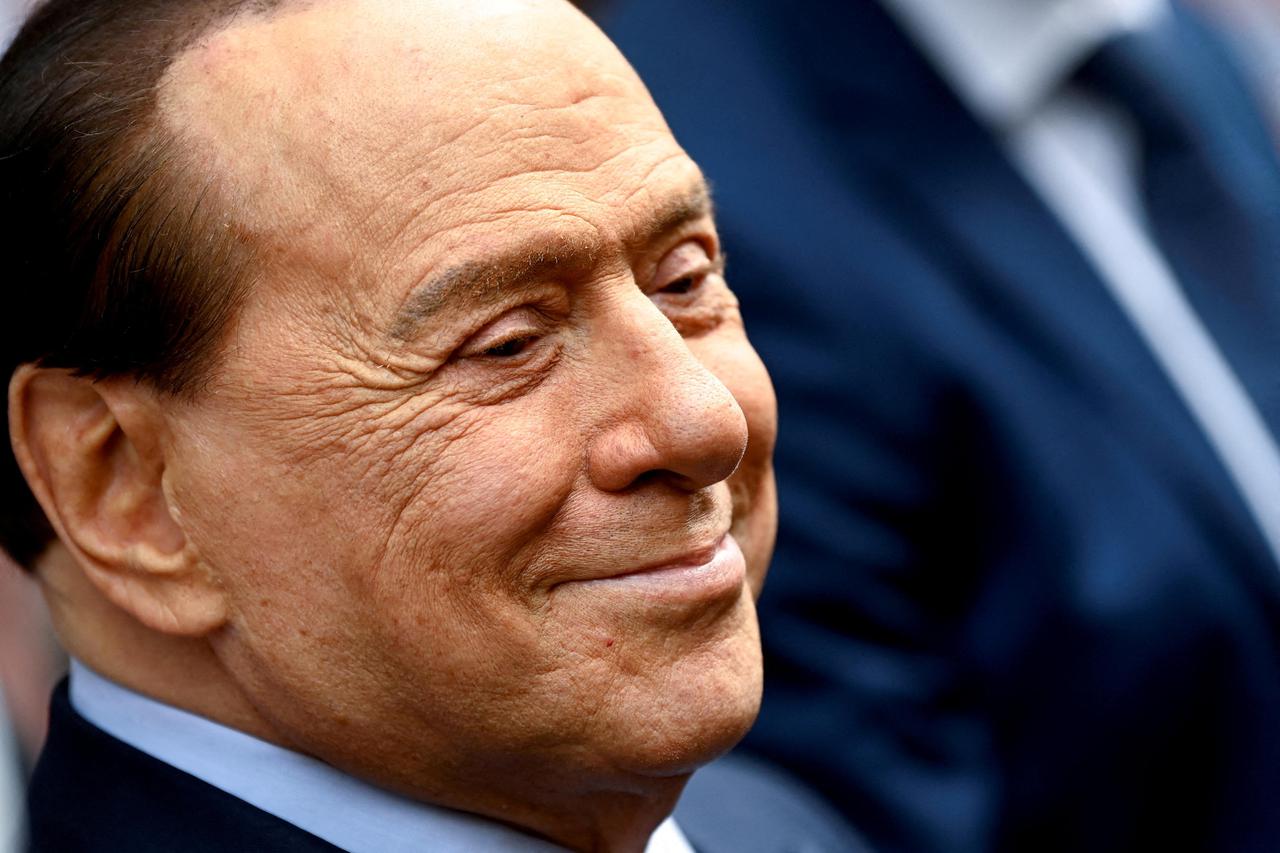 FILE PHOTO: Italy's former prime minister, Silvio Berlusconi, reacts after casting his vote during Italian elections for mayors and councillors