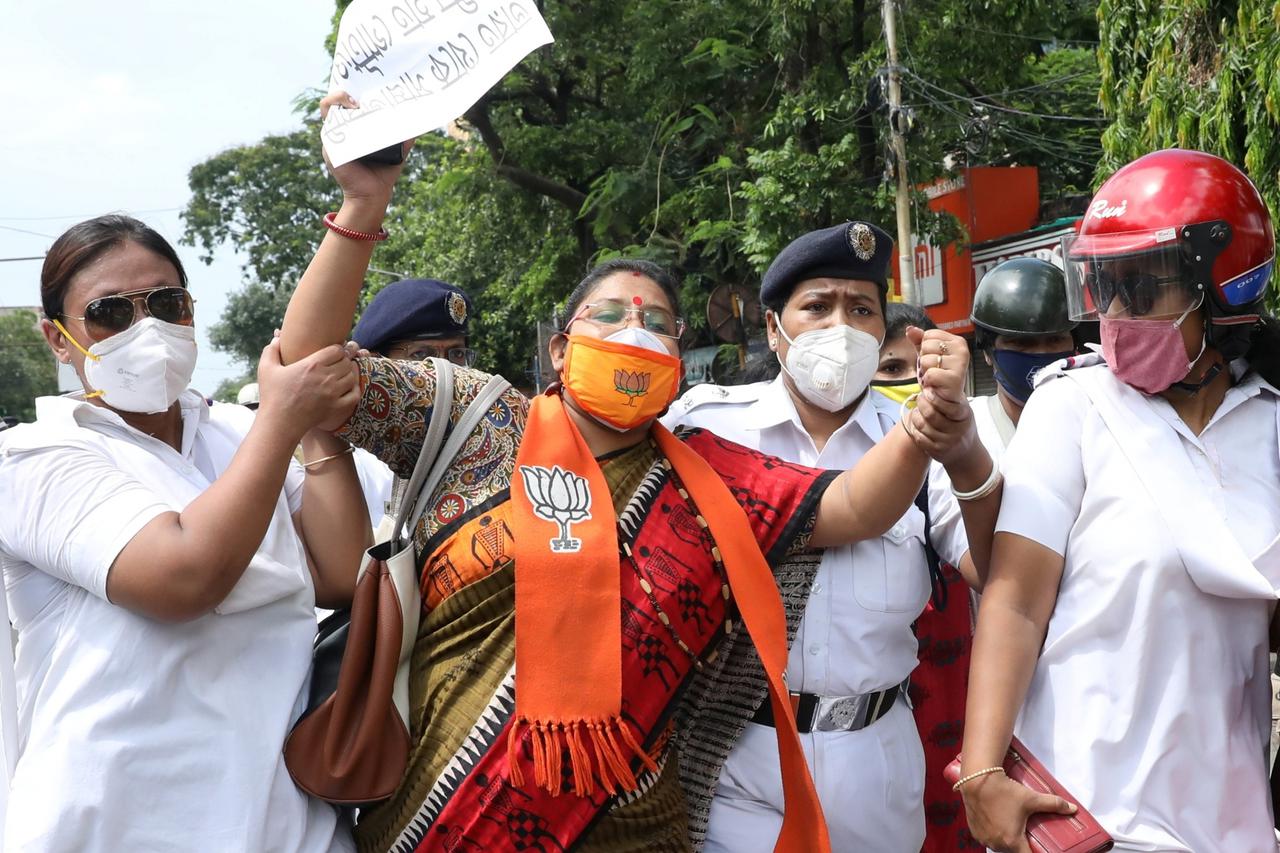 A supporter of India's ruling BJP reacts as she is detained by the police during a protest against China, in Kolkata