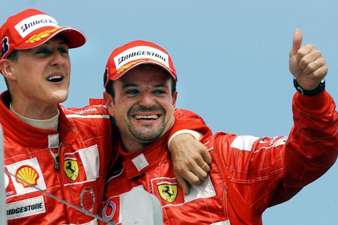 'Ferrari F1 teammates German Michael Schumacher (L) and Brazilian Rubens Barrichello (R) celebrate after Schumacher won 2004 Grand Prix of Canada and Barichello finished third, 13 June, 2004, at the C