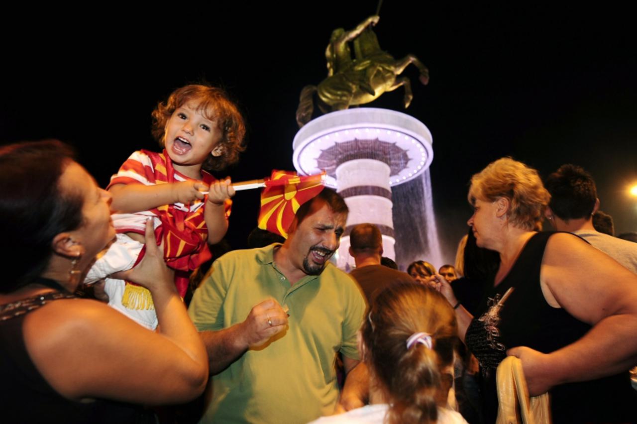 \'Macedonians celebrate 20 years of independence next to a bronze statue of Alexander the Great in Skopje September 8, 2011. Tens of thousands of Macedonians took to the streets on Thursday to mark 20