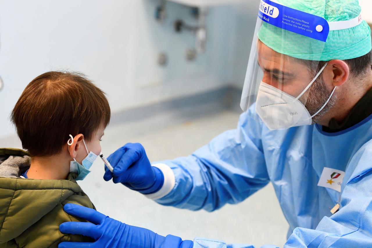 Children receive a flu vaccine in a military hospital