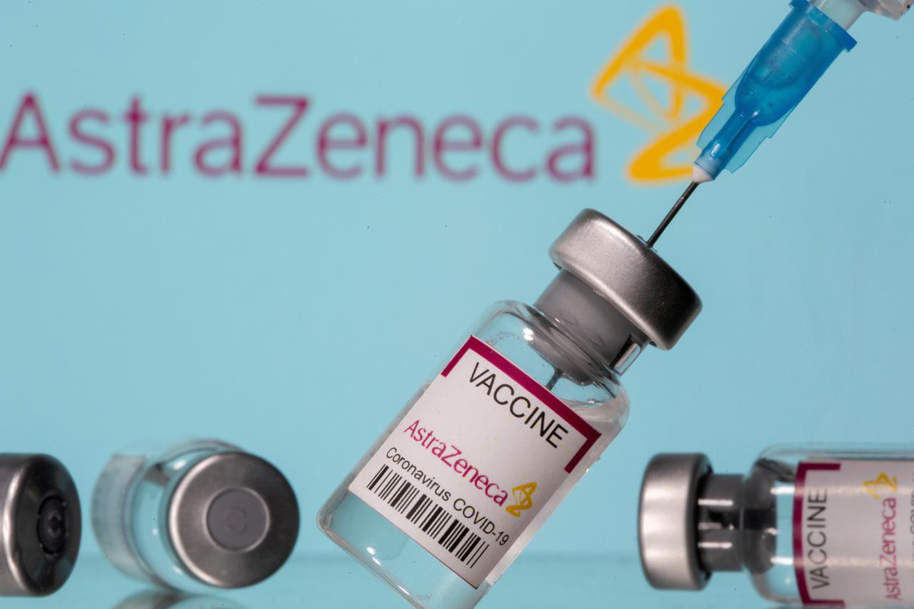 FILE PHOTO: Vials labelled "Astra Zeneca COVID-19 Coronavirus Vaccine" and a syringe are seen in front of a displayed AstraZeneca logo in this illustration photo