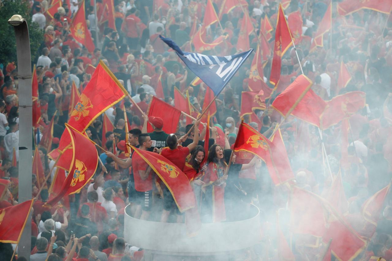 Participants wave flags during a post-election patriotic rally in Podgorica