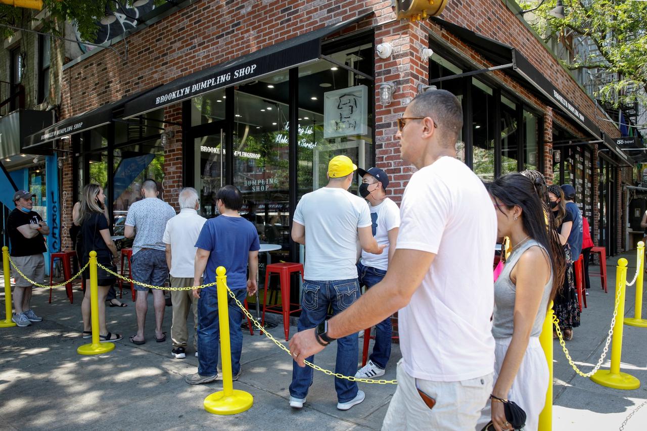 Customers stand in line for the opening of the Brooklyn Dumpling Shop in New York
