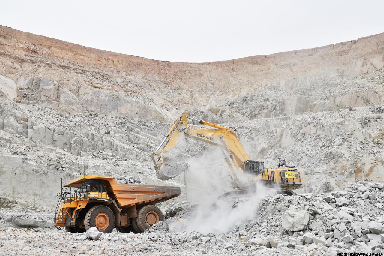 FILE PHOTO: An excavator driven by Rosalie Guirou Kulga, 30, clears out rocks into a dumper at the gold mine, operated by Endeavour Mining Corporation in Hounde