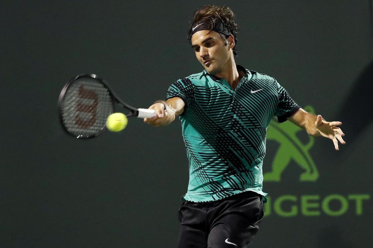 Mar 31, 2017; Miami, FL, USA; Roger Federer of Switzerland hits a forehand against Nick Kyrgios of Australia (not pictured) during a men's singles semi-final in the 2017 Miami Open at Brandon Park Tennis Center. Federer won 7-6(9), 6-7(9), 7-6(5). Mandato
