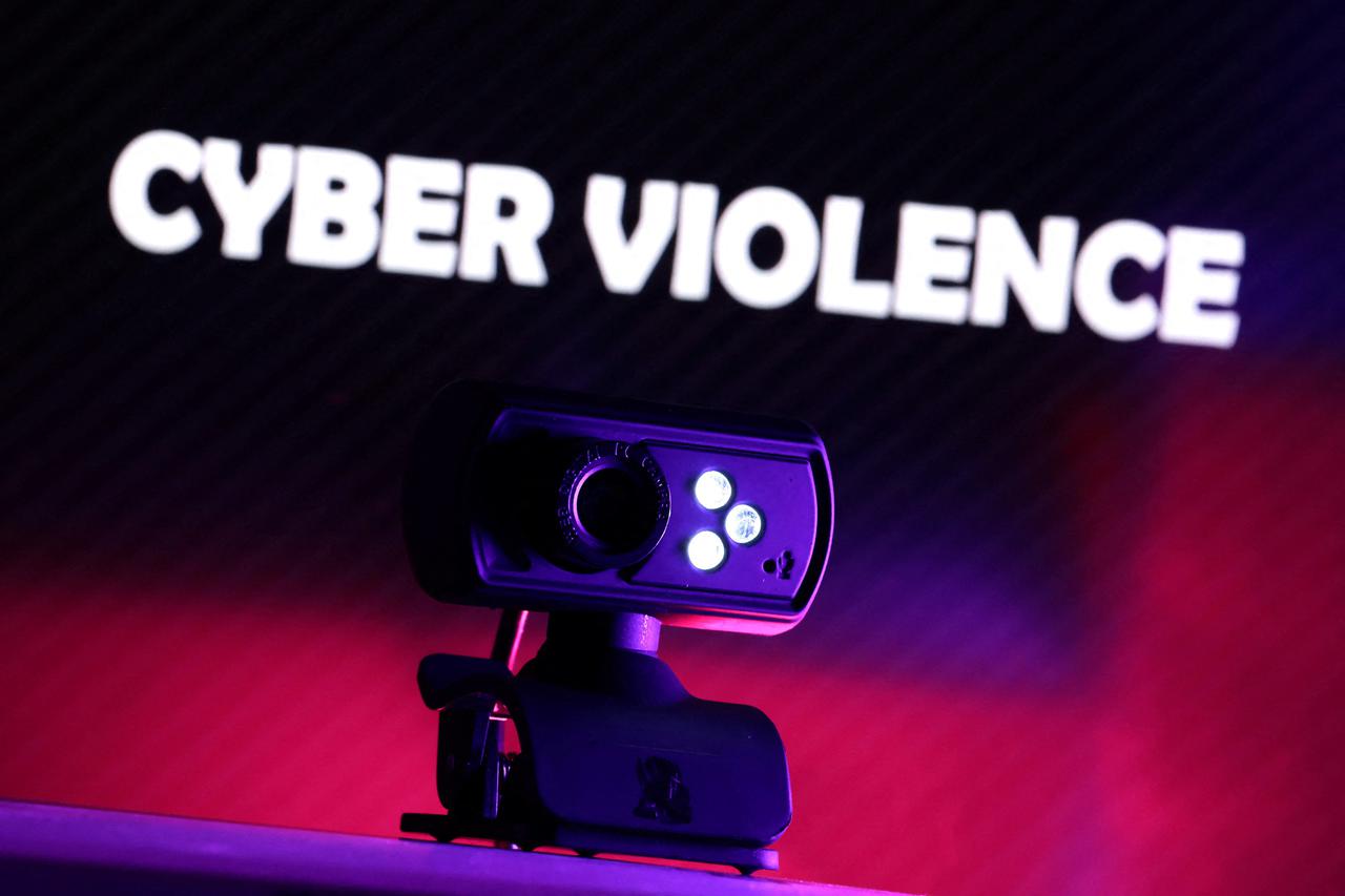 Illustration shows a web camera and displayed words "Cyber violence\