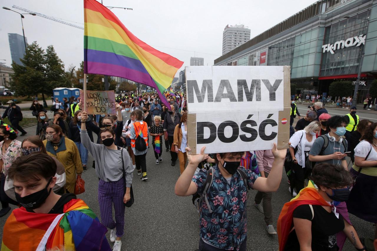 Pro-LGBT demonstrators hold banner reading "We have enough" in Warsaw