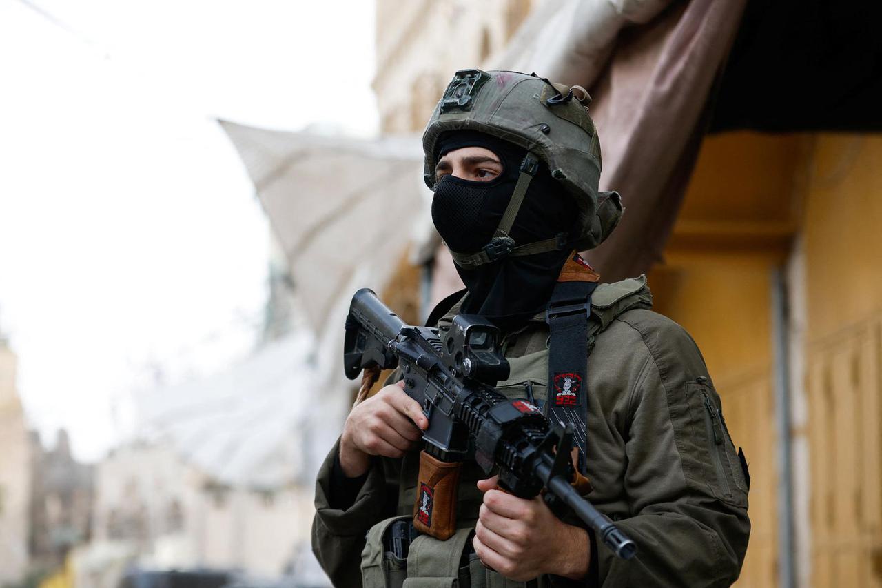 Israeli soldiers stand guard during a weekly settlers' tour in Hebron