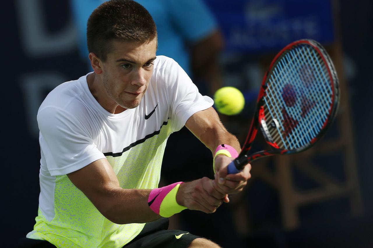 Borna Coric of Croatia hits a return to Andy Murray of Britain during their men's singles quarter-final match at the ATP Championships tennis tournament in Dubai February 26, 2015. REUTERS/Ahmed Jadallah (UNITED ARAB EMIRATES - Tags: SPORT TENNIS)
