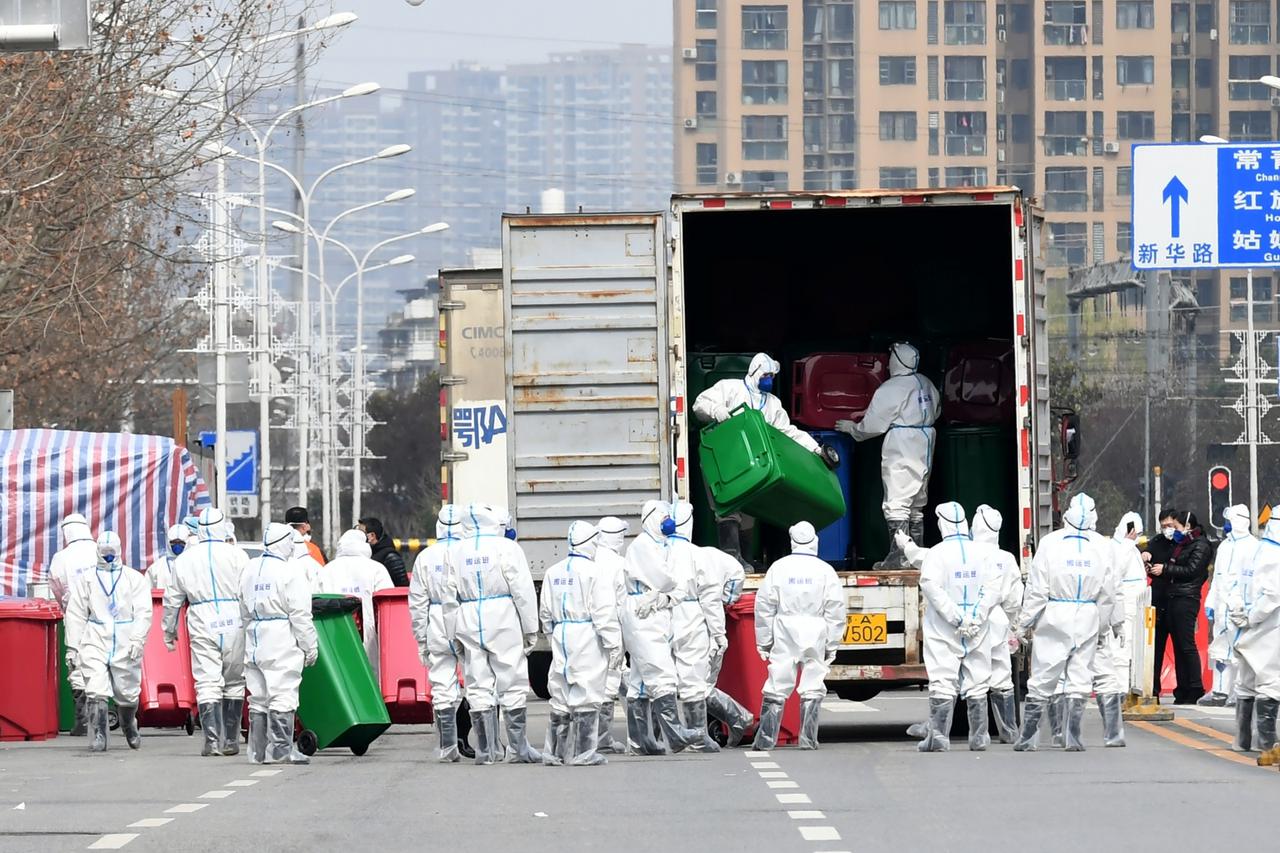Workers in protective suits take part in the disinfection of Huanan seafood market, where the novel coronavirus is believed to have first surfaced, in Wuhan