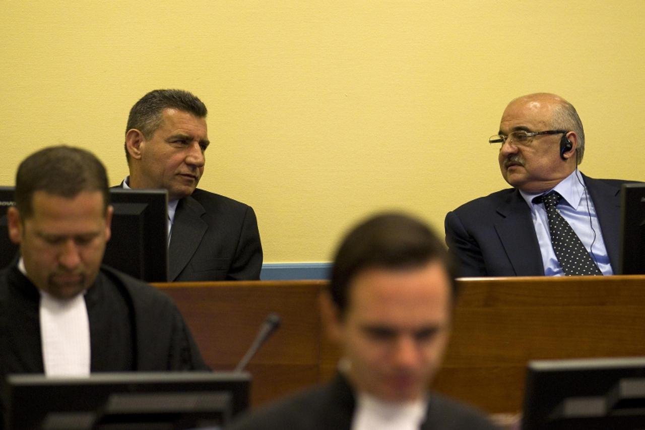 'Former Croatian Army General Ante Gotovina (L) talks to Ivan Cermak in the court room before the International Criminal Tribunal for the former Yugoslavia (ICTY) in The Hague, April 15, 2011. The tri