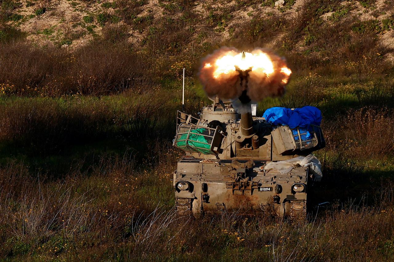 An Israeli artillery unit fires towards Gaza, near the northern Gaza Strip border