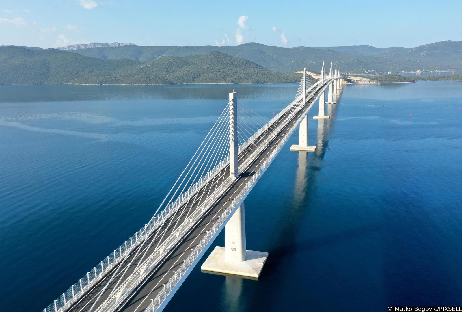 26.07.2023., Komarna - Pogled iz zraka na Peljeski most koji je otvoren 26. srpnja 2022. godine. Most je dugacak 2404 metara i naveca visina iznad mora iznosi 55 metara. Glavna je prometna poveznica kontinentalne Hrvatske s poluotokom Peljescem. Photo: Matko Begovic/PIXSELL