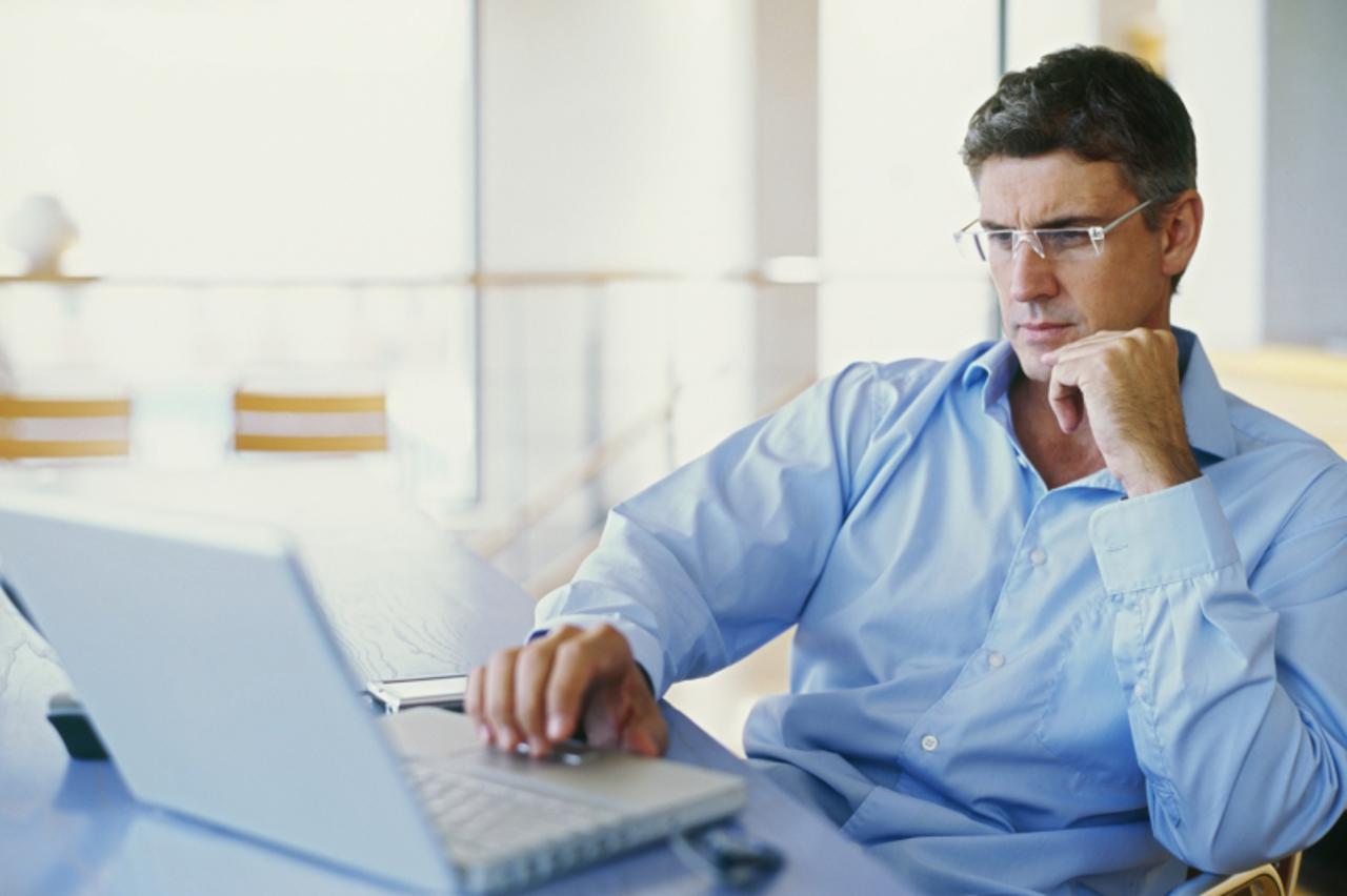 'businessman using a laptop in an office'