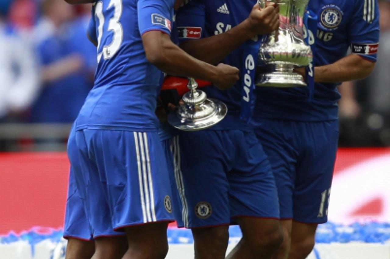 'Chelsea players (L-R) Daniel Sturridge, Ashley Cole, Didier Drogba and Michael Ballack celebrate with the trophy after the FA Cup final soccer match against Portsmouth at Wembley Stadium in London, M