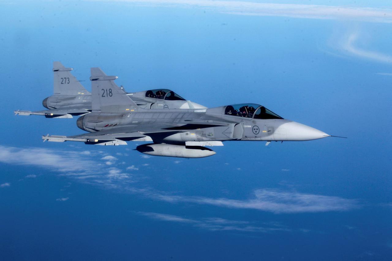 FILE PHOTO: Sweden's Air Force "Grippen" fighters are seen as they escort a Lithuania's Air Force C-27J plane during NATO joint military exercise in Siauliai