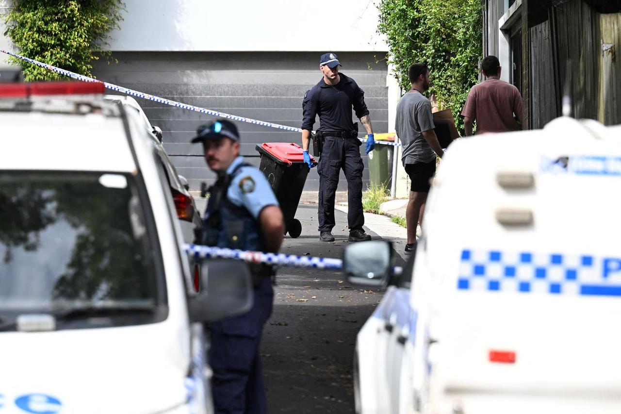 Police officers work at a crime scene in Paddington