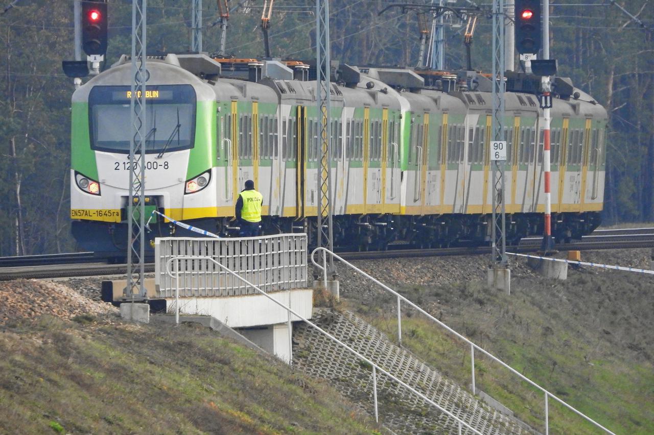 Policeman stands near the train at the site of the blast on railways on the Warsaw-Lublin line in Mika
