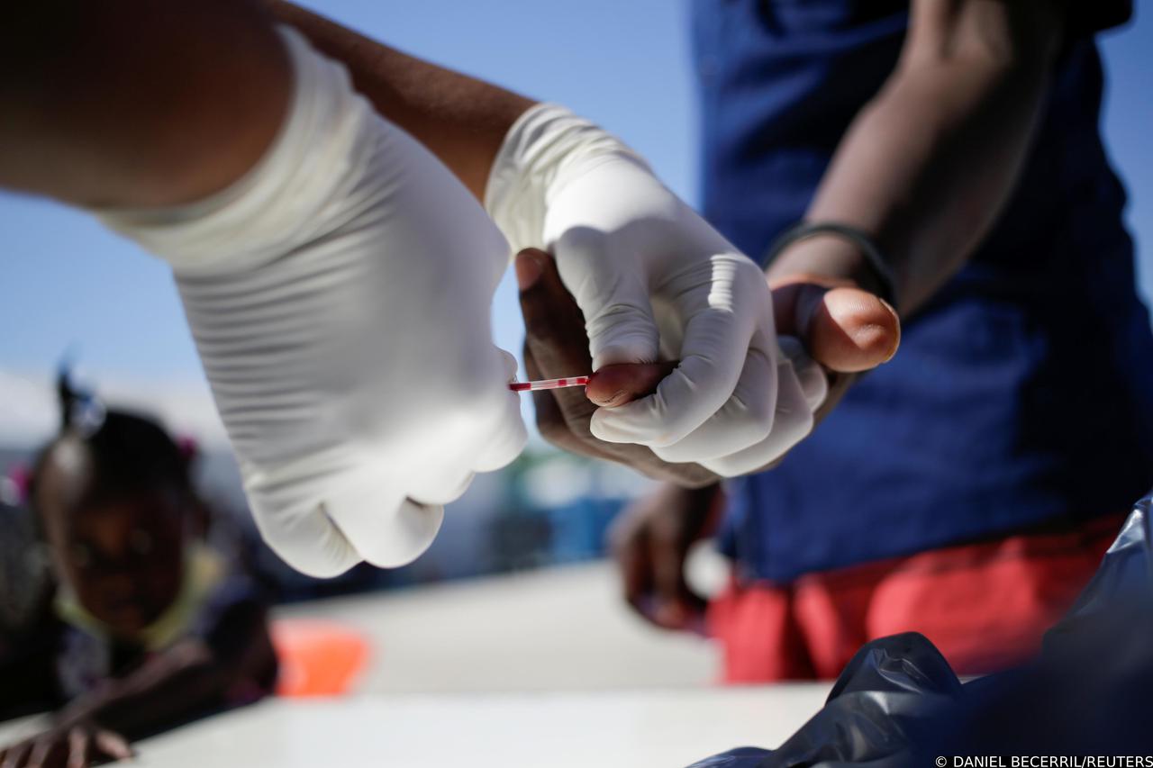 Asylum-seeking migrants in the U.S. return to the Mexican side of the border in Ciudad Acuna