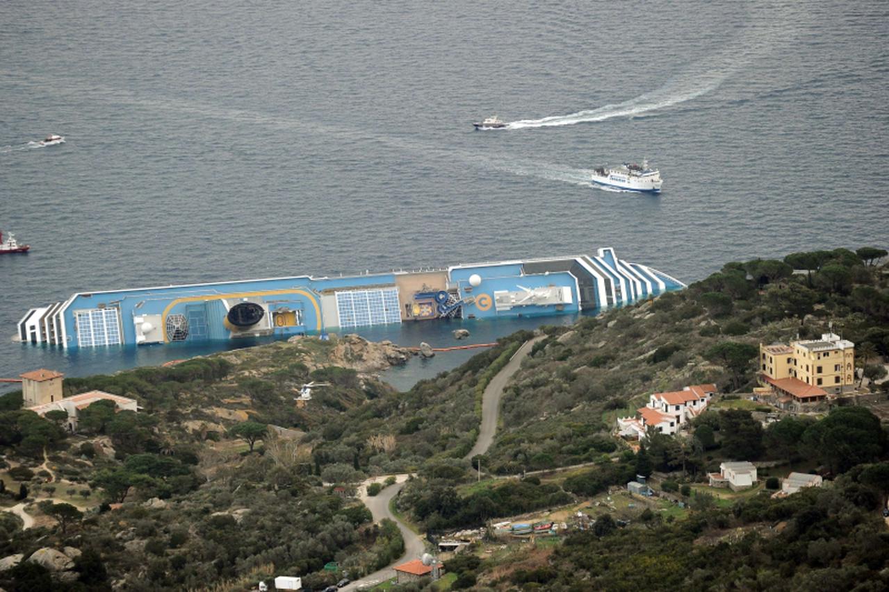 'This picture shows a view on January 18, 2012 of the cruise liner Costa Concordia aground in front of the harbour of the Isola del Giglio (Giglio island) after hitting underwater rocks on January 13.