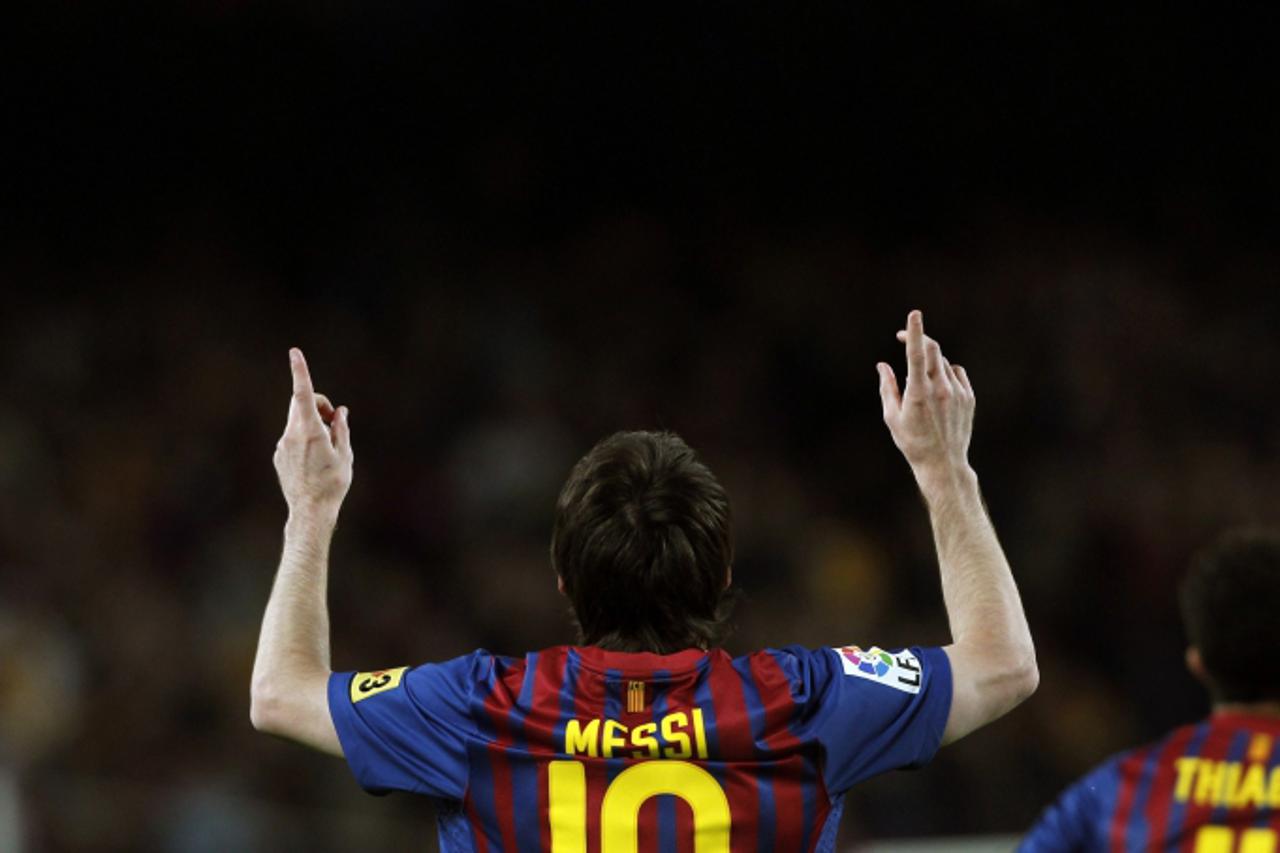'Barcelona\'s Lionel Messi celebrates a goal against Espanyol during their Spanish first division soccer match at Camp Nou stadium in Barcelona May 5, 2012. REUTERS/Albert Gea (SPAIN - Tags: SPORT SOC