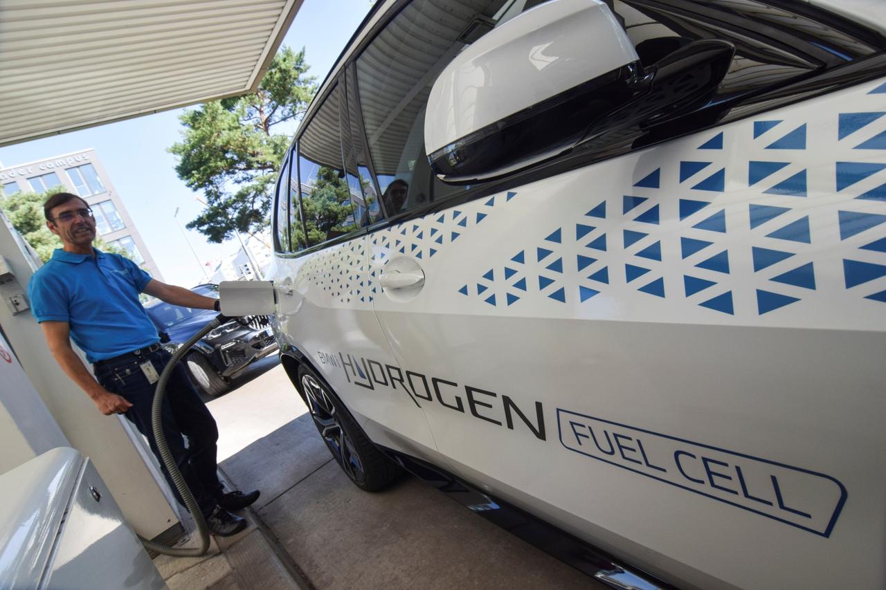 Juergen Guldner, a vice president at BMW in charge of the carmaker's hydrogen car program, fuels a hydrogen fuel-cell prototype SUV at a petrol station in Munich