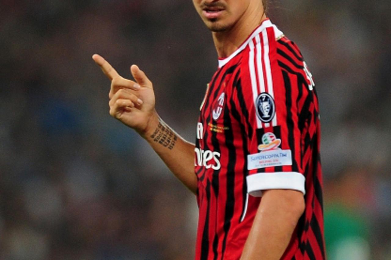 'AC Milan\'s Zlatan Ibrahimovic of Sweden reacts during the Italian Super Cup 2011 football match against Inter Milan, at China\'s National Stadium, known as Bird\'s Nest, in Beijing on August 6, 2011