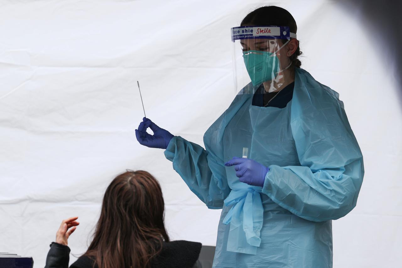 A medical worker administers a test for COVID-19 on a member of the public in Sydney