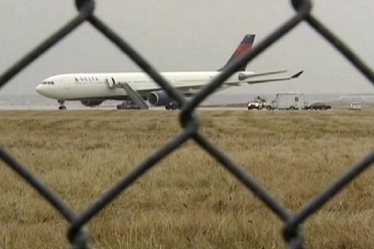 'REFILE - UPDATING CAPTION   A Delta Airbus 330 airliner sits on a runway at Detroit Metropolitan Airport in Romulus, Michigan in this video grab made December 25, 2009. A man reportedly set off firec