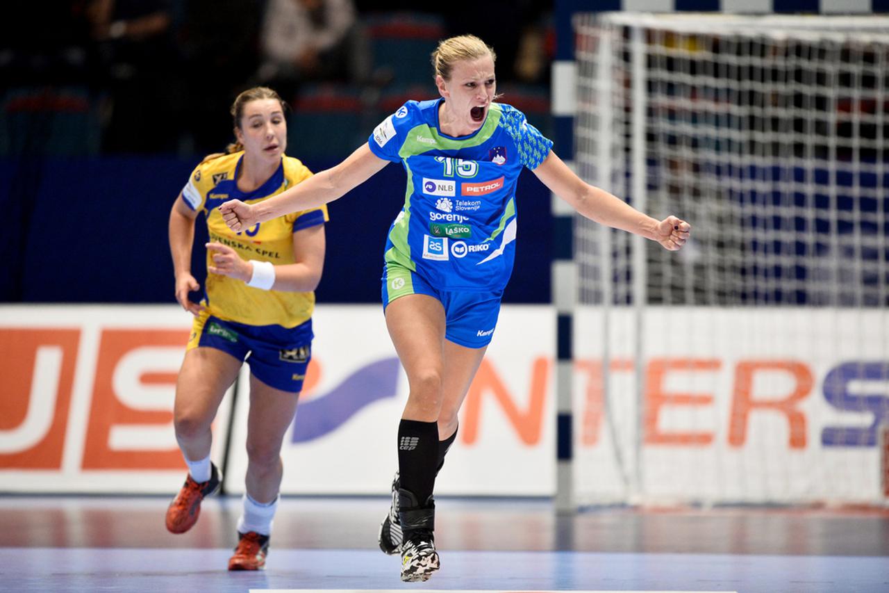 Slovenia's Barbara Lazovic celebrates scoring as Sweden's Anna Lagerquist looks on during the European Women's Handball Championship group A match between Slovenia and Sweden at Hovet Arena in Stockholm, Sweden, Dec. 06, 2016. TT NEWS AGENCY/Anders Wiklun