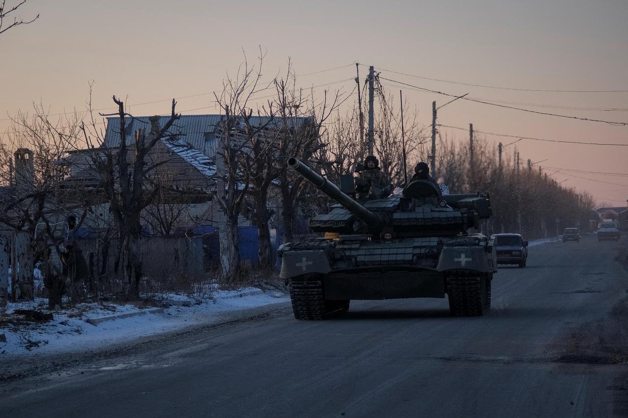 Ukrainian service members ride a tank near Lyman