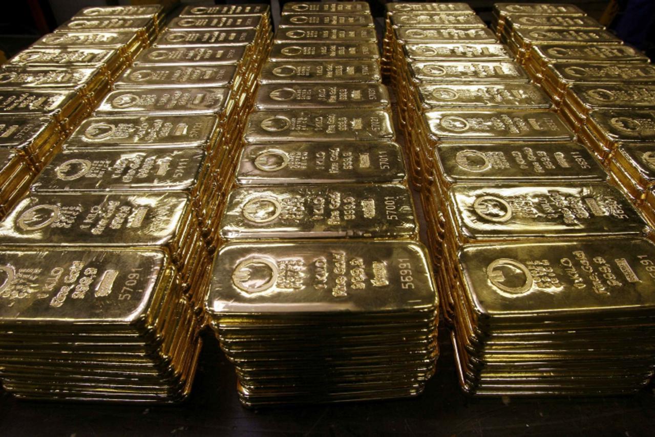 'Gold bars are displayed on a table at a plant of gold refiner and bar manufacturer Argor-Heraeus SA in the southern Swiss town of Mendrisio in this November 13, 2008 file photo. Sealed off by grey co