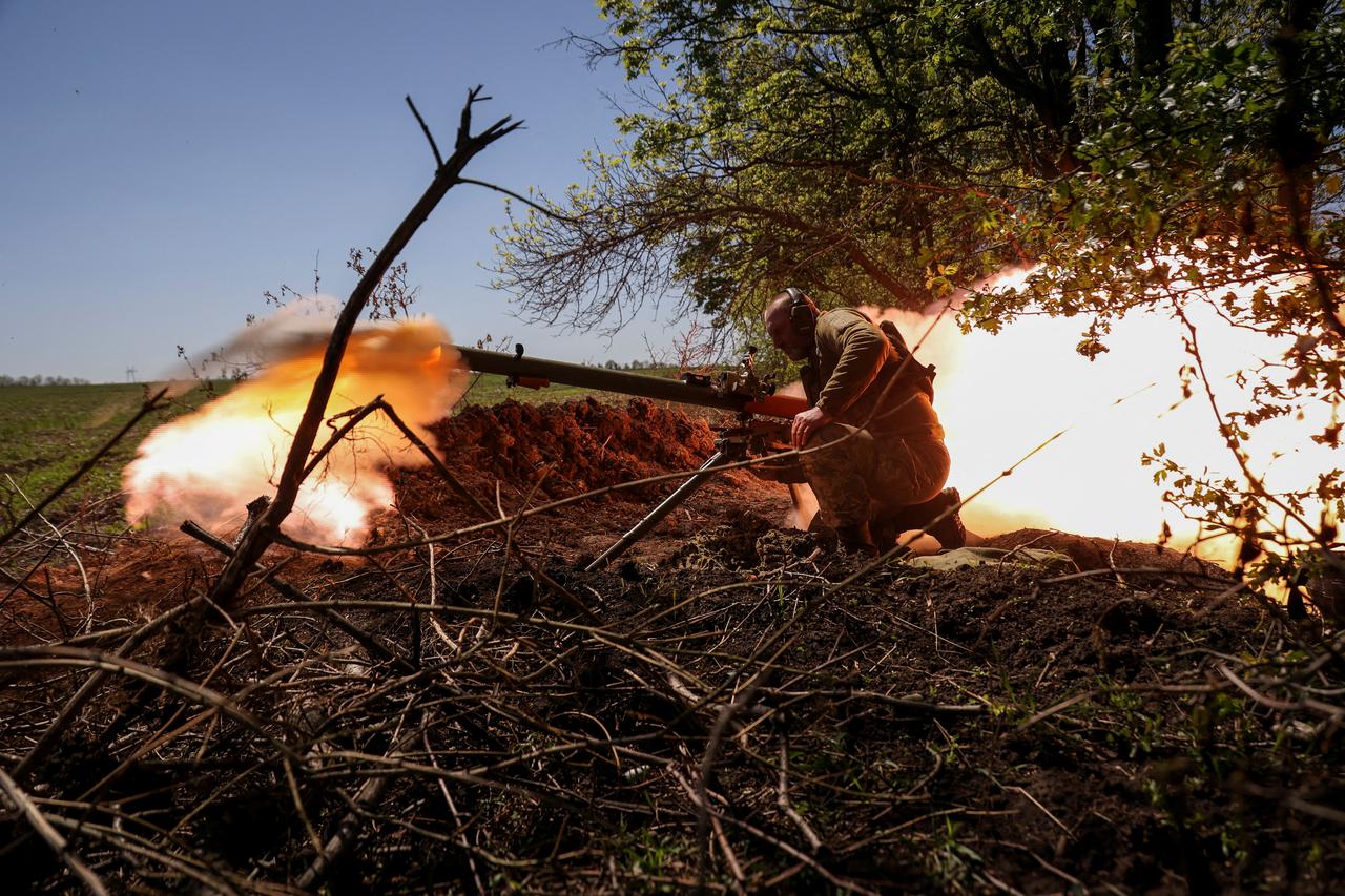 A Ukrainian service member fires an anti-tank grenade launcher at a front line near the city of Bakhmut
