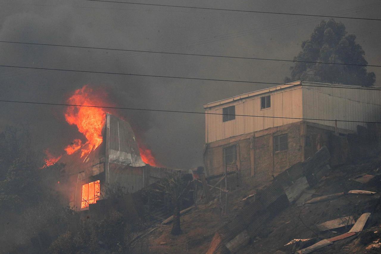 A house burns amid the spread of wildfires in Vina del Mar