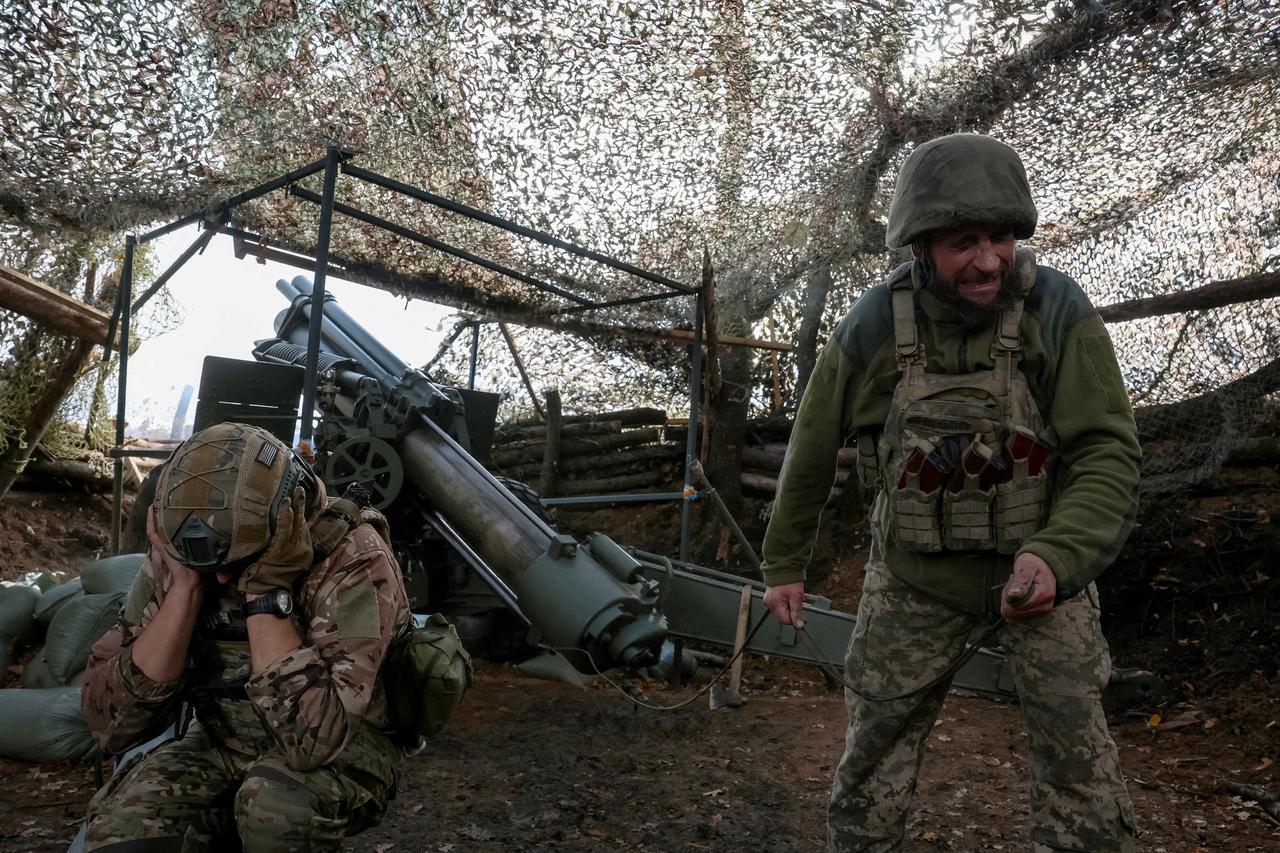 FILE PHOTO: Ukrainian servicemen fire a self-propelled howitzer towards Russian troops near the frontline town of Pokrovsk