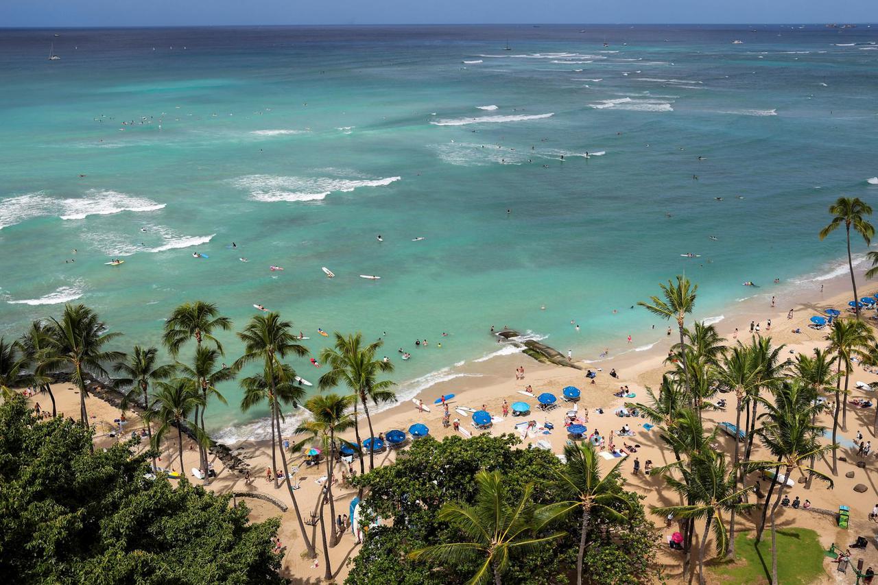 Vacationers return to beaches after tsunami warnings were downgraded in Honolulu