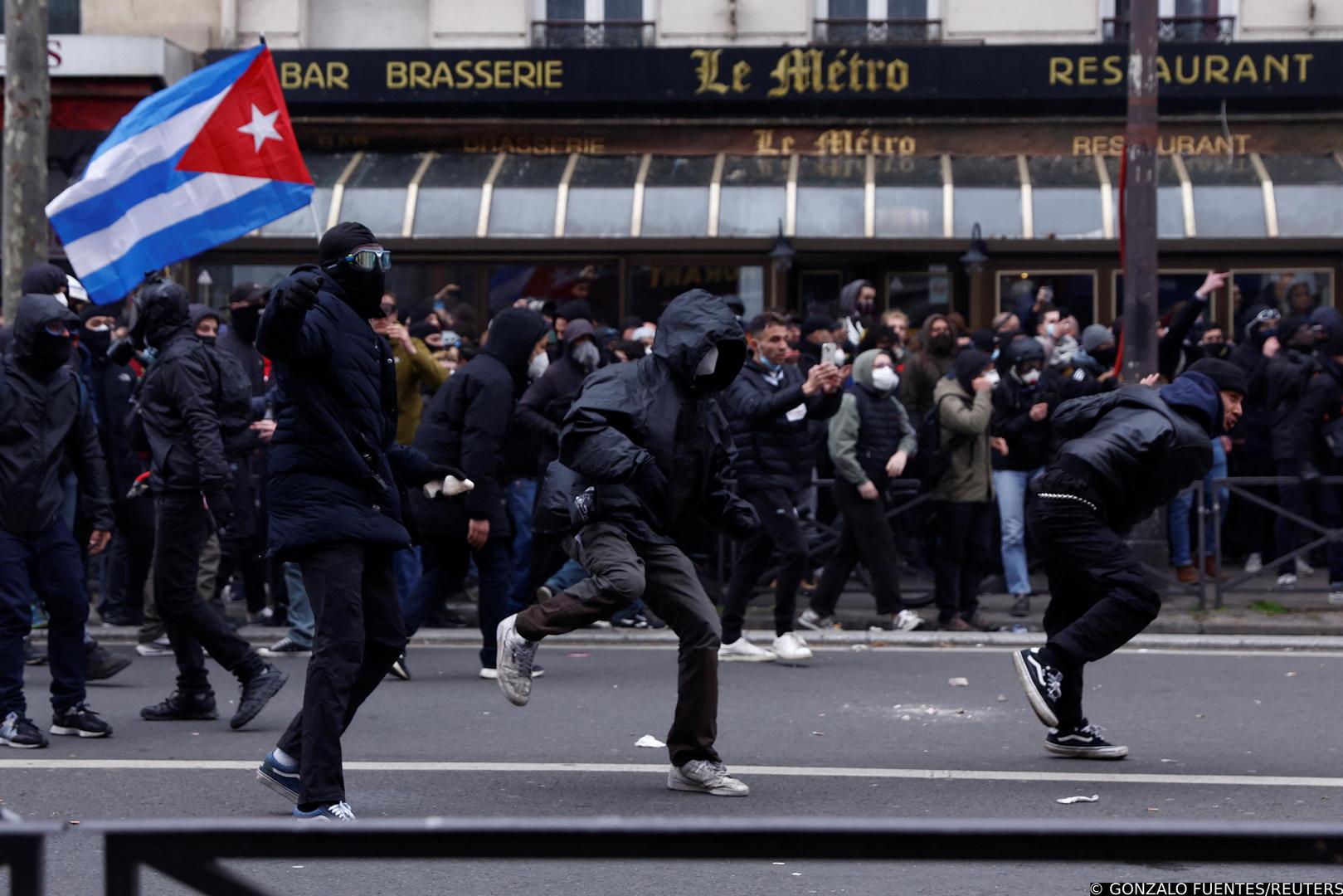 Masked protesters react during clashes at a demonstration as part of the tenth day of nationwide strikes and protests against French government's pension reform, in Paris, France, March 28, 2023. REUTERS/Gonzalo Fuentes Photo: GONZALO FUENTES/REUTERS