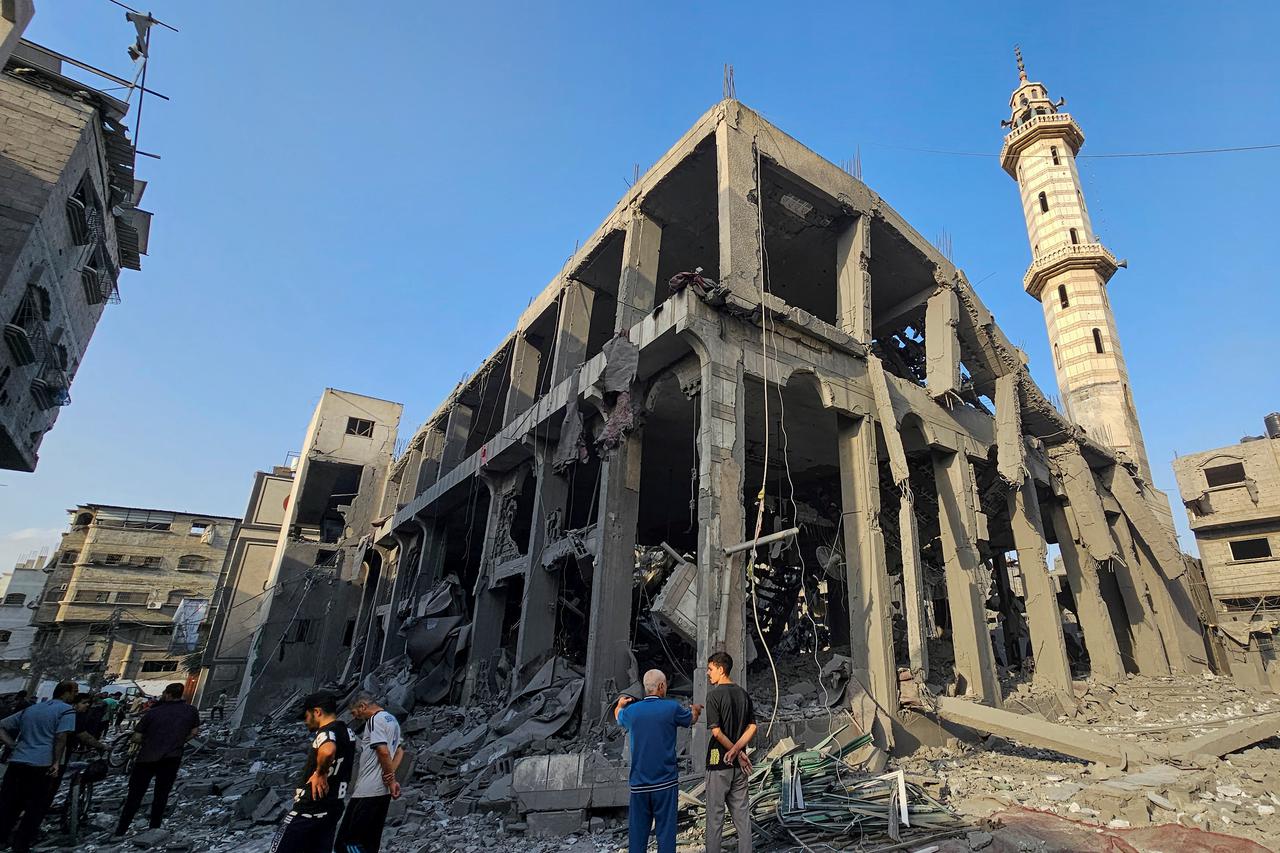 Palestinians inspect the remains of a mosque destroyed in Israeli strikes, in the northern Gaza Strip