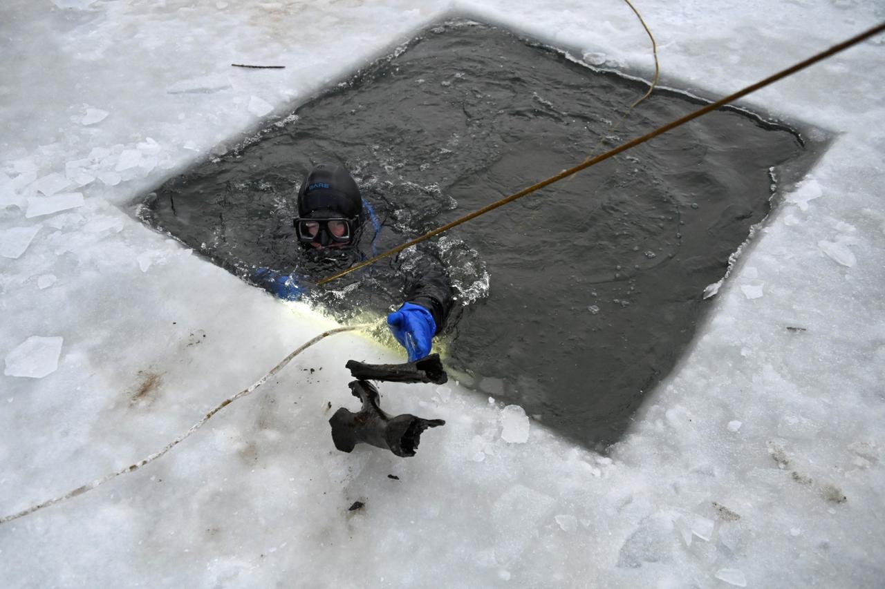 Diver Yaroslav Makarov lifts fossilized bones from the bottom of the Tobol River in Kurgan