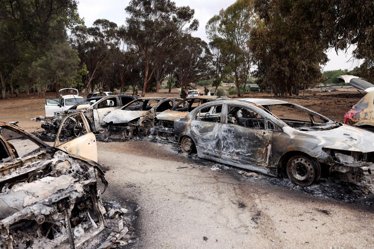 Burnt cars are abandoned in a carpark near where a festival was held before an attack by Hamas gunmen from Gaza that left at least 260 people dead, by Israel's border with Gaza in southern Israel