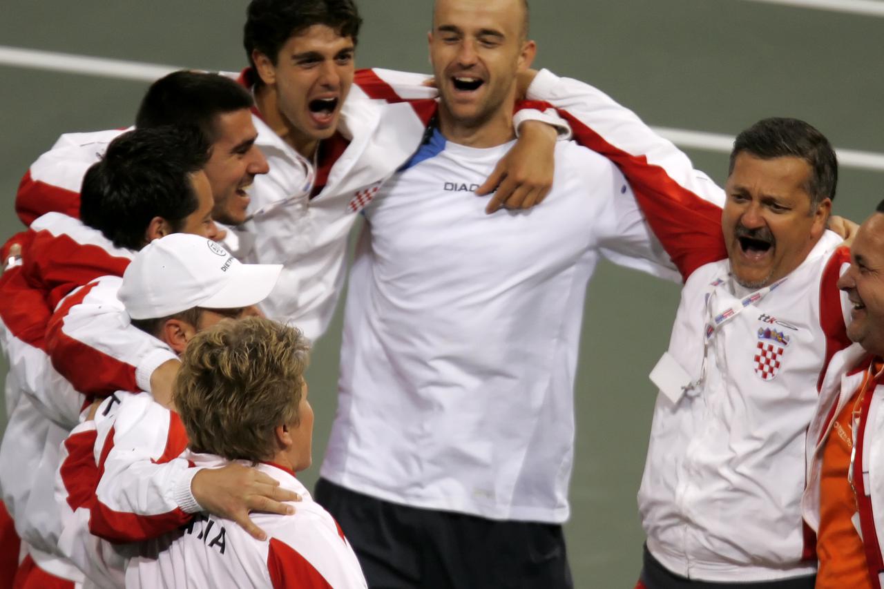 Ivan Ljubicic (C) of Croatia celebrates with teammate Mario Ancic (L) and other teammates after defeating Andy Roddick of the U.S. in Carson, California March 6, 2005. Croatia took a 3-1 lead over the United States after the opening reverse singles in the
