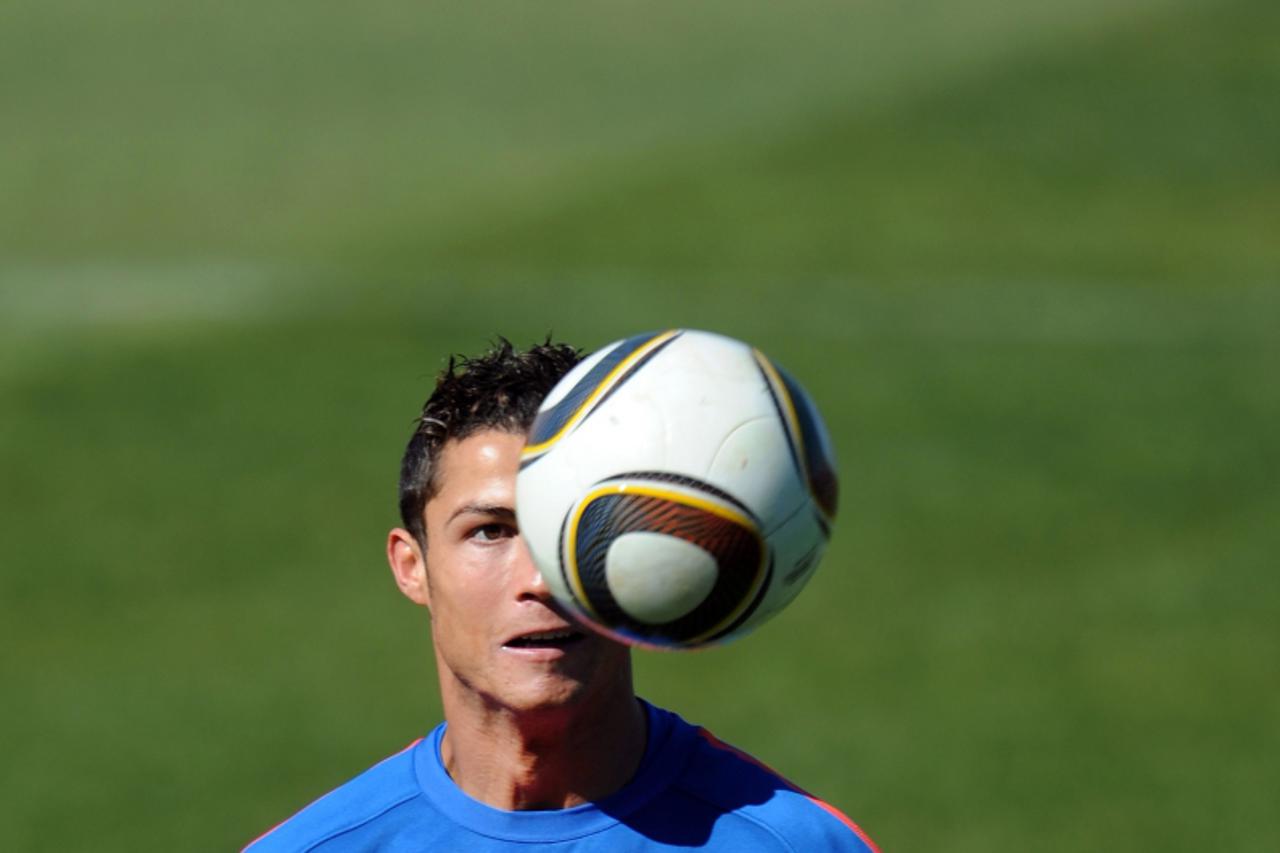 'Portugal\'s striker Cristiano Ronaldo eyes the ball during a training session at Bekker High School in Magaliesburg on June 19, 2010. Portugal will face North Korea on June 21 in Cape Town in their n
