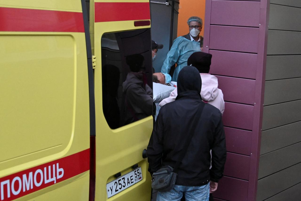 An ambulance transporting Russian opposition leader Alexei Navalny drives out of a hospital in Omsk