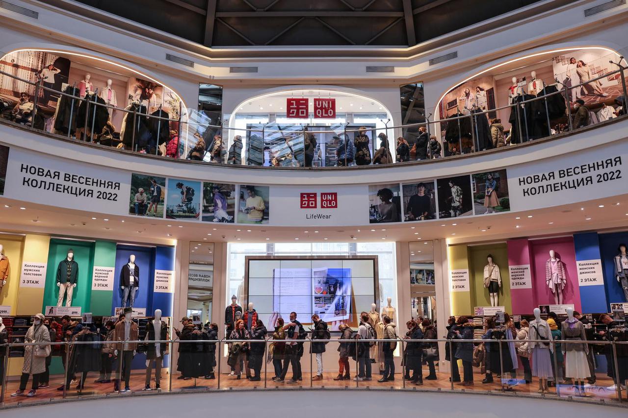 Customers queue to enter a Uniqlo store in Moscow