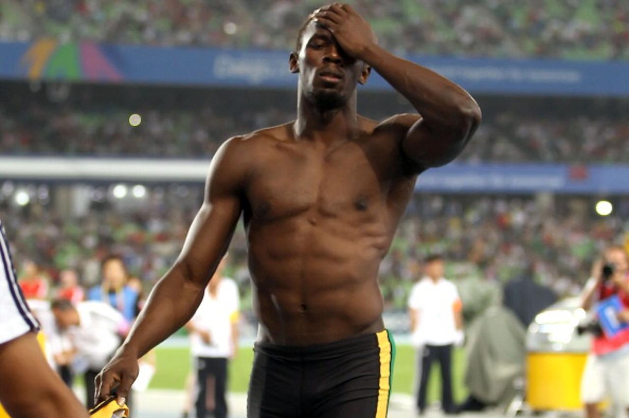 'DAEGU, SOUTH KOREA - AUGUST 28:  Usain Bolt of Jamaica shows his dejection after being disqualified for a false start in the Men\'s 100 metre final during day two of 13th IAAF World Athletics Champio