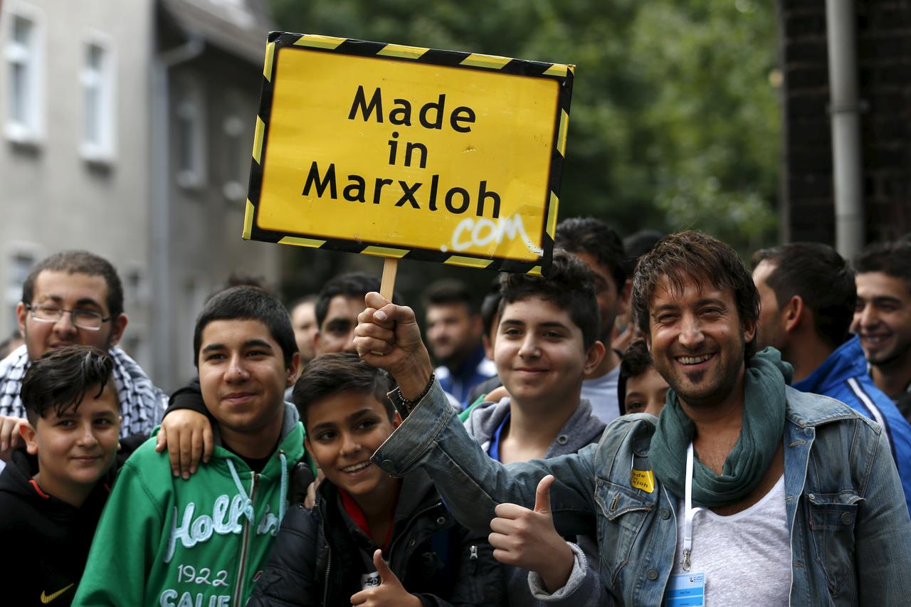 Residents of Duisburg's district Marxloh hold up a sign reading, 